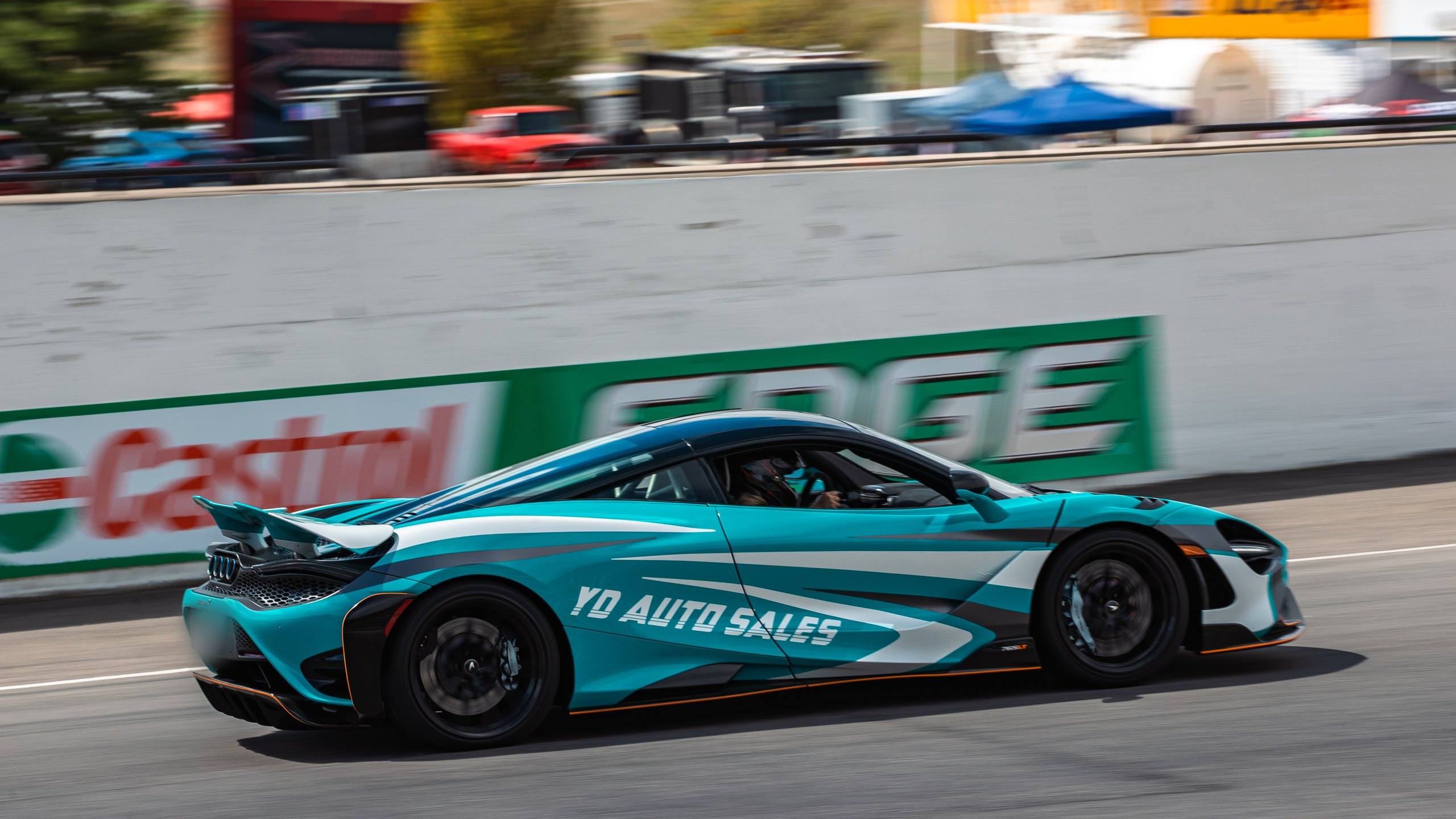 McLaren 765LT in YD Auto Sales livery at speed on track at the 2023 Drive Festival.